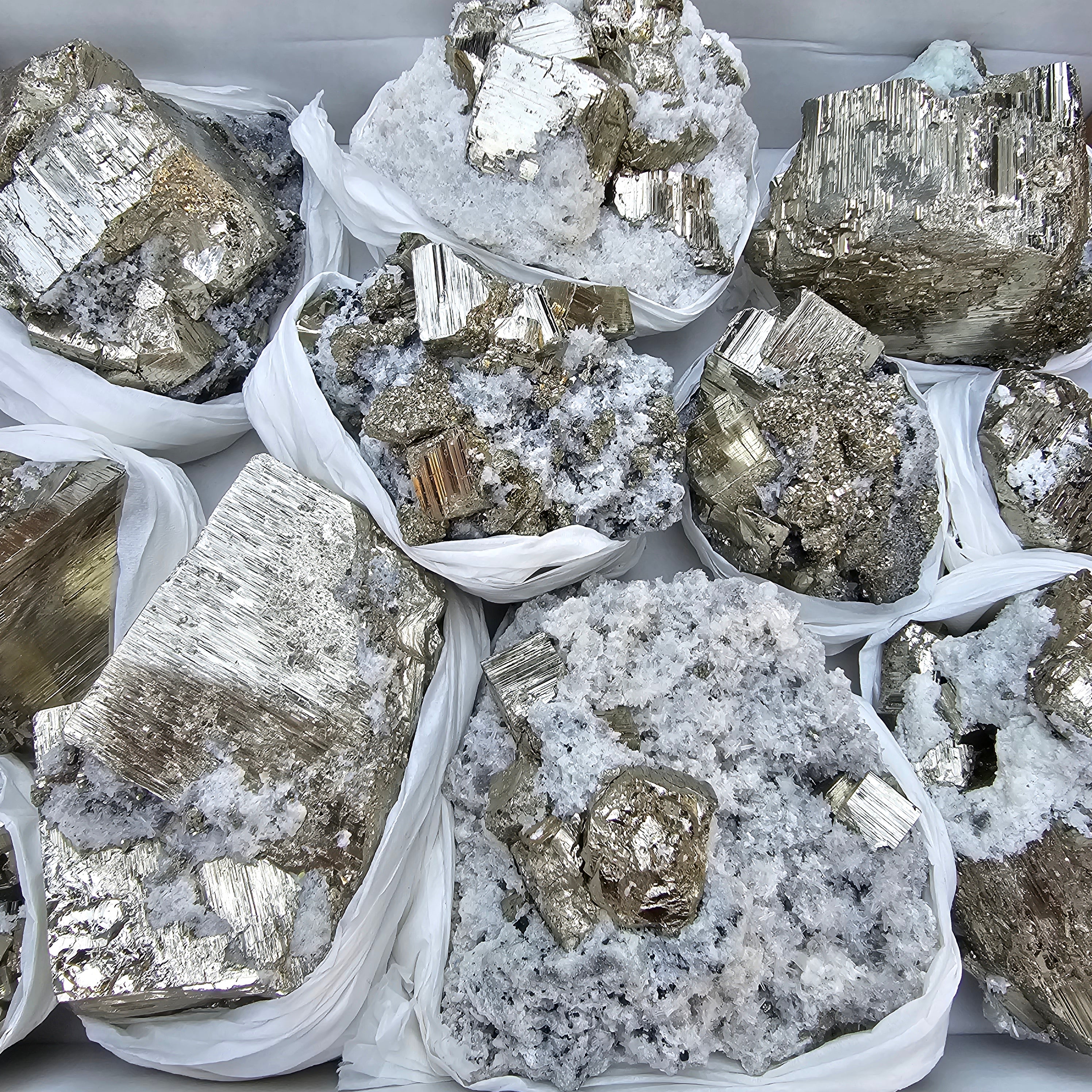 11 pc Pyrite Cubic with calcite flourecent